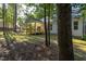 Backyard with trees shows the house and covered deck at 6069 Jones Cir, Sanford, NC 27332