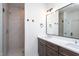 Bathroom with double vanity, a large mirror, and tiled shower at 6069 Jones Cir, Sanford, NC 27332