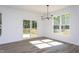 Dining room features sliding glass door to deck and multiple windows allowing for ample natural light at 6069 Jones Cir, Sanford, NC 27332