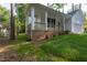 Inviting covered porch with brick base and wooden railings, perfect for outdoor enjoyment at 6069 Jones Cir, Sanford, NC 27332