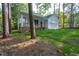 Exterior of house featuring garage and covered porch surrounded by trees at 6069 Jones Cir, Sanford, NC 27332