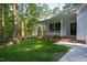 Charming home exterior featuring a quaint porch, well-kept lawn, and lush surrounding trees at 6069 Jones Cir, Sanford, NC 27332