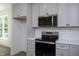 Stainless steel range and microwave oven with white subway backsplash at 6069 Jones Cir, Sanford, NC 27332