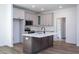 Modern kitchen with a central island, stainless appliances, and white cabinets at 6069 Jones Cir, Sanford, NC 27332