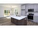 Spacious kitchen with a large island, stainless appliances, and sliding doors to the deck at 6069 Jones Cir, Sanford, NC 27332