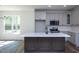 Open kitchen featuring an island, stainless appliances, and ample natural light at 6069 Jones Cir, Sanford, NC 27332