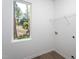 Well-lit laundry room with large window and vinyl flooring at 6069 Jones Cir, Sanford, NC 27332