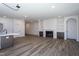 Large living room featuring modern floors, a fireplace, and built-in bookshelves at 6069 Jones Cir, Sanford, NC 27332