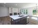 Open-concept living room with island, stainless appliances, lots of light, and a view into the living room at 6069 Jones Cir, Sanford, NC 27332