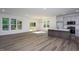 Open-concept living area featuring sleek floors, a modern kitchen, and ample natural light at 6069 Jones Cir, Sanford, NC 27332