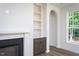 Living room with archway, built-in shelving, and modern fireplace at 6069 Jones Cir, Sanford, NC 27332