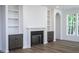 Bright living room with a fireplace, built-in shelving, and neutral color scheme at 6069 Jones Cir, Sanford, NC 27332