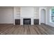 Spacious living room featuring a fireplace, built-in shelving, and neutral color palette at 6069 Jones Cir, Sanford, NC 27332