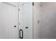 White doors into a shower tiled in neutral-toned rectangular tiles, with a shower head at 6069 Jones Cir, Sanford, NC 27332