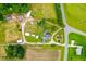Comprehensive aerial photograph showcasing a property with various structures and expansive acreage at 6318 Hurdle Mills Rd, Roxboro, NC 27574