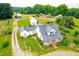 Beautiful home with a metal roof, inviting front porch and charming landscaping at 6318 Hurdle Mills Rd, Roxboro, NC 27574