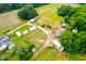 Birds eye view of the home, featuring a cluster of outbuildings and plenty of land at 6318 Hurdle Mills Rd, Roxboro, NC 27574