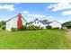 Expansive backyard featuring a charming white home, and lush greenery at 6318 Hurdle Mills Rd, Roxboro, NC 27574
