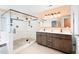 Bathroom with glass-enclosed shower, double vanity, and neutral tile, offering a spa-like experience at 6318 Hurdle Mills Rd, Roxboro, NC 27574