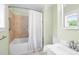 Cozy bathroom featuring a tub with a shower and a bright window at 6318 Hurdle Mills Rd, Roxboro, NC 27574