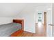 Cozy bedroom with wooden floors and access to additional rooms in the home at 6318 Hurdle Mills Rd, Roxboro, NC 27574