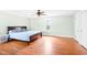 Tranquil bedroom with hardwood floors, ceiling fan, and natural light, ideal for relaxation at 6318 Hurdle Mills Rd, Roxboro, NC 27574