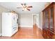 Classic dining room featuring wood floors, a ceiling fan, and a beautiful cabinet at 6318 Hurdle Mills Rd, Roxboro, NC 27574