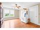 Bright dining room with hardwood floors, ceiling fan, and large windows at 6318 Hurdle Mills Rd, Roxboro, NC 27574