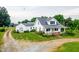 Charming two story home features a covered front porch, metal roof and lovely landscaping at 6318 Hurdle Mills Rd, Roxboro, NC 27574