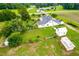 Aerial view of home, featuring a well-maintained lawn and outbuildings at 6318 Hurdle Mills Rd, Roxboro, NC 27574