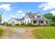 Picturesque farmhouse with a metal roof, inviting porch, and sprawling yard at 6318 Hurdle Mills Rd, Roxboro, NC 27574