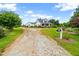 Expansive property showcasing a well-maintained lawn, long driveway, and classic farmhouse architecture at 6318 Hurdle Mills Rd, Roxboro, NC 27574