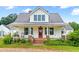 Inviting front porch with a red door, brick steps, and lovely landscaping at 6318 Hurdle Mills Rd, Roxboro, NC 27574