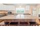 Bright kitchen with a large island, breakfast bar, and plenty of natural light at 6318 Hurdle Mills Rd, Roxboro, NC 27574