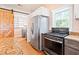 Stylish kitchen with barn door access, stainless steel appliances and granite counters at 6318 Hurdle Mills Rd, Roxboro, NC 27574