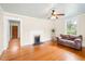 Bright living room featuring hardwood floors, a fireplace, and neutral paint at 6318 Hurdle Mills Rd, Roxboro, NC 27574