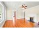 Open living area with gleaming hardwood floors, fireplace, and ample natural light at 6318 Hurdle Mills Rd, Roxboro, NC 27574