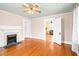 Charming living room with beautiful hardwood floors and a cozy fireplace, flowing into additional living spaces at 6318 Hurdle Mills Rd, Roxboro, NC 27574