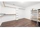 Walk-in closet with shelving, hanging rods, and wood floors, providing ample storage space at 6318 Hurdle Mills Rd, Roxboro, NC 27574