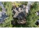 An aerial view shows the roof, backyard entertaining space, and surrounding mature landscaping at 633 Rolling Springs Dr, Cary, NC 27519