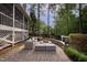 Beautiful outdoor living space with stone patio, outdoor furniture, and a cozy fire pit area at 633 Rolling Springs Dr, Cary, NC 27519
