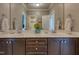 Bathroom featuring double vanity, stone countertop, and decorative wallpaper at 633 Rolling Springs Dr, Cary, NC 27519