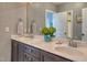 Bathroom featuring double vanity, stone countertop, and decorative wallpaper at 633 Rolling Springs Dr, Cary, NC 27519