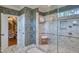 Elegant bathroom with glass shower, patterned wallpaper and marble floors, exudes sophisticated style at 633 Rolling Springs Dr, Cary, NC 27519