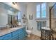Stylish bathroom featuring a custom blue vanity, granite countertop, and tiled shower at 633 Rolling Springs Dr, Cary, NC 27519