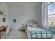 Bright bedroom with a large window, cozy bed, and a charming desk area at 633 Rolling Springs Dr, Cary, NC 27519