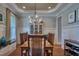 Elegant dining room with decorative ceiling, chandelier, and seating for six at 633 Rolling Springs Dr, Cary, NC 27519