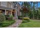 Beautiful home featuring stone accents, a stone chimney, and professionally landscaped surroundings at 633 Rolling Springs Dr, Cary, NC 27519