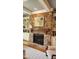 Stone fireplace with a decorative mantle and built-in shelving in the living room for a warm and inviting atmosphere at 633 Rolling Springs Dr, Cary, NC 27519
