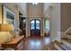 Grand foyer with hardwood floors, an ornate front door, and decorative molding throughout at 633 Rolling Springs Dr, Cary, NC 27519